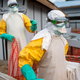 In this photograph taken Saturday July 13, 2019, health workers wearing protective suits take their shift at a treatment center in Beni, Congo DRC.